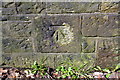 Benchmark on the wall on the west side of New Road
