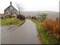 Minor road and The Old Kirk, formerly Lower Cabrach Church, near Bridgend