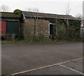 Partly overgrown building at the southern edge of Abergavenny railway station car park 