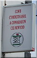 Welsh side of the New Quay Sports & Social Club name sign, New Quay