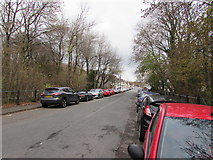 ST1494 : Car-lined and tree-lined part of Station Road, Ystrad Mynach by Jaggery