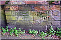 Benchmark on wall pier on south side of Westcotes Drive