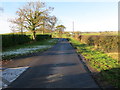 Minor road approaching the B6364 road at Legars