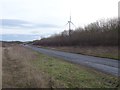 NZ2497 : New road and Widdrington Wind Farm by Richard Webb
