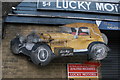 View of the shop sign for Lucky Motors on Druid Street