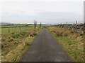 Fence and wall-lined Cross Lane heading towards Rouster Green