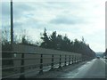 A57 eastbound passes over railway bridge