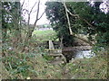 J0114 : Remains of a cross-border footbridge over the Forkhill River by Eric Jones