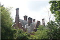 View of one of the almshouses through the trees on St. John