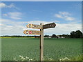 Sign post and beyond the wheat, Field Barn from Brandon Road