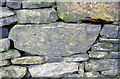 Benchmark on stone in wall on NW side of Wood Nook Lane