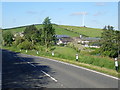 Farm buildings on either side of the A25 (Newtown Road)