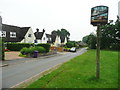 Houses and village sign, Tea Green