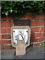 Old sluice valve marker hidden behind modern version on Ffriddoedd Road, Bangor