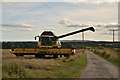 NJ8721 : Combined Harvester near Woodend Farm, Aberdeenshire by Andrew Tryon
