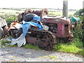 Old caterpillar tracked tractor beside the lane