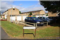 Block of garages and houses on Colyers Avenue at Highbrook junction