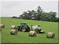 NT4621 : Wrapping  bales  of  hay  in  field  with  tractor by Martin Dawes