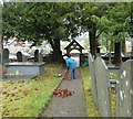 SH7352 :  Sweeping leaves St Gwyddelan, Dolwyddelan by Gerald England