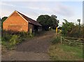 Footpath passing farm building east of Wysall Lane