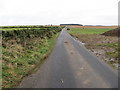 NK0059 : Minor road passing between arable and grazing land near to Cortiebrae by Peter Wood