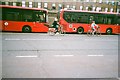 TQ3183 : View of two buses and two cyclists on Tolpuddle Street by Robert Lamb