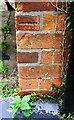 Benchmark on house on NW side of Gorse Lane