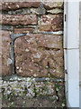 Weathered bench mark in Meols Parade, Wirral