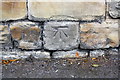 Benchmark on wall on southeast side of Savile Road