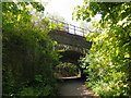 Path beneath Waterloo to Portsmouth line, with 450 class train running overhead