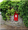 King George VI postbox in a stone wall, Llantarnam, Cwmbran