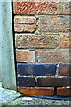 Benchmark on integral garage of No. 135 Evington Lane