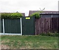 Garden gate in fence on Kirby Lane westwards