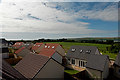 Looking across rooftops towards West Penhill Farm