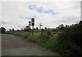 NZ0614 : Abbey  Bridge  traffic  light  and  footpath  fingerpost by Martin Dawes