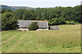 Farm building in hillside meadow