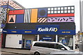 View of Kwik Fit on Leyton High Street with Camille Walala art above