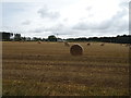 Stubble field with bales near Denhead