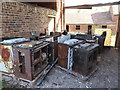 Old barn with a collection of derelict stoves or ovens