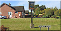 TG2902 : Yelverton village sign by Adrian S Pye