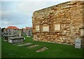 Old priory wall and gravestones