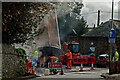 Resurfacing the road following remedial work on a drainage system