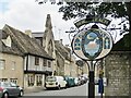 SP1114 : Northleach - Village Sign by Colin Smith