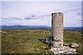 NN8285 : Wind-clipped heath and trig point at summit of Leathad an Taobhain by Trevor Littlewood