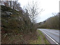 Walking beside the A49 road with old red sandstone hills to our left