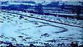 Earthwork building in the snow at Bryn Cysegrfan