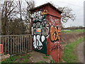 View of a bridge abutment covered in graffiti on the path next to the Roding