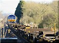 Mostly empty container train hauled by Class 66 727 "Maritime One" leaving Glebe Road level crossing