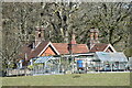 Cottage with glasshouses and ornate chimney stacks