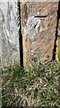 Benchmark on gatepost at gateway on north side of road opposite Faugh Head